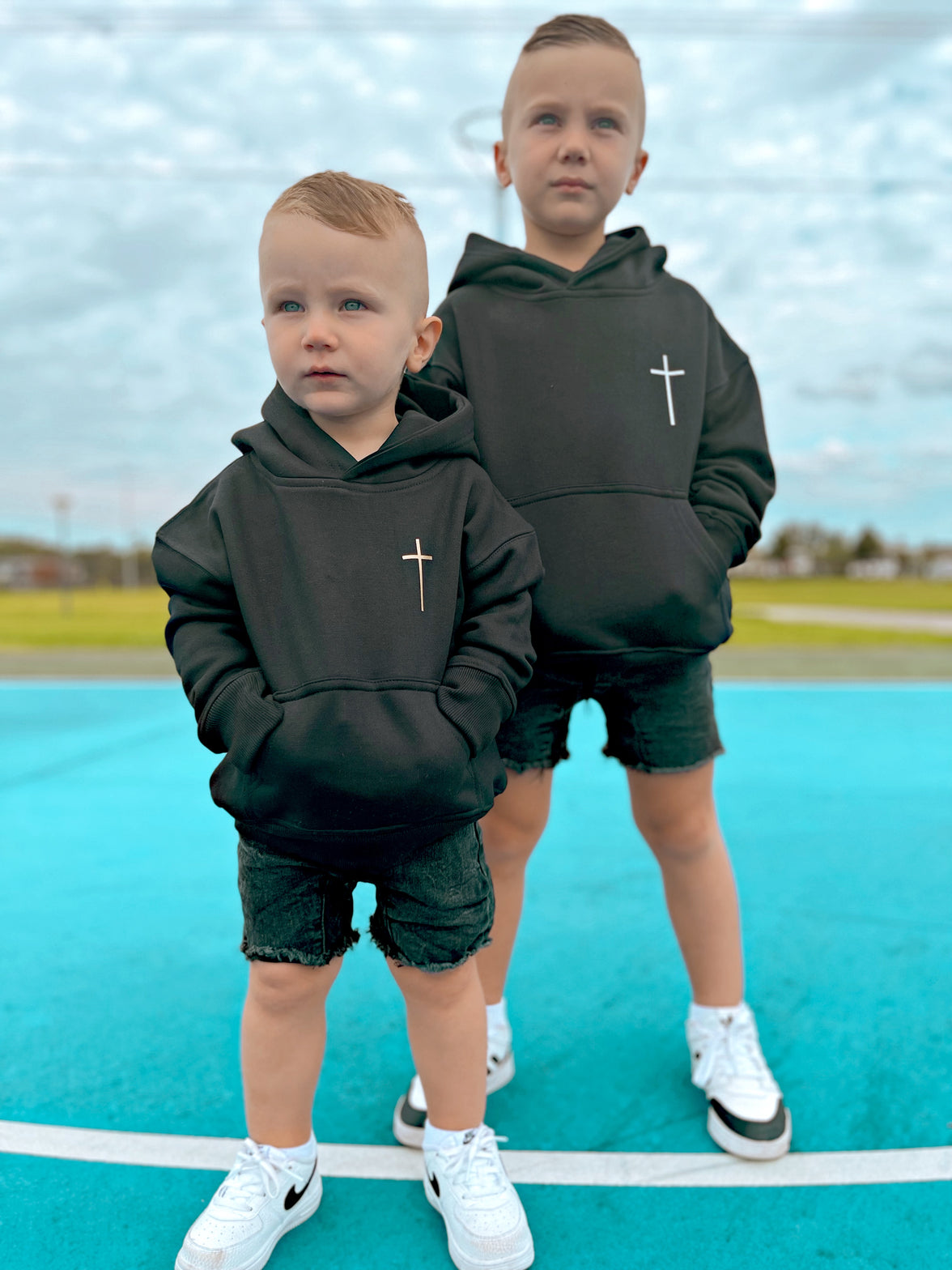 Two boys wearing black Jesus Is King kids hoodies, front view | WORDOFGOD Apparel
