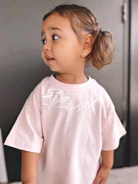 Toddler wearing a pink custom curved name tee | WORDOFGOD Apparel